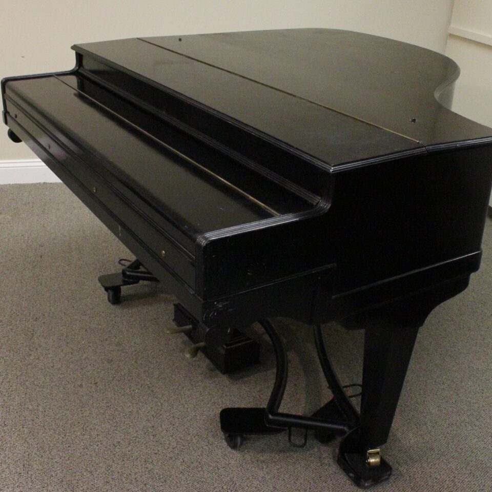 George Rogers down striking grand piano closed case